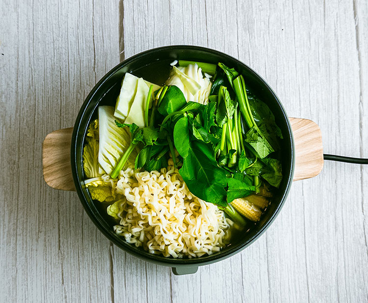hot pot cooker with vegetables, mushrooms and noodles